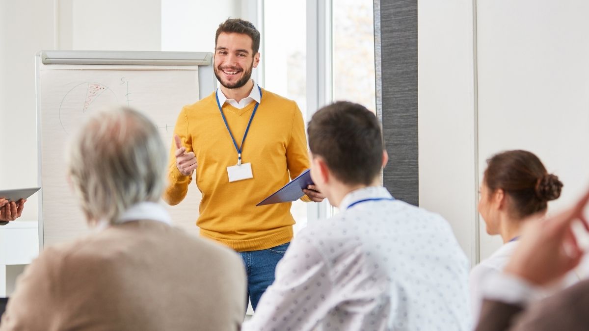 Male professional presenting to his team during a corporate public speaking training session