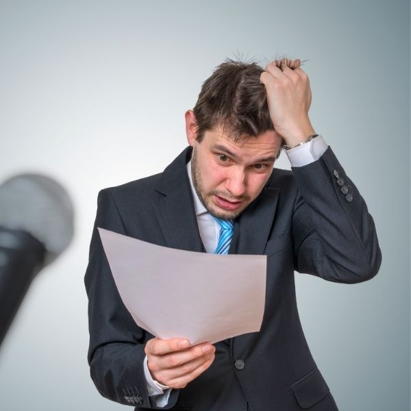 Best man looking stressed while trying to memorise his speech from a piece of paper