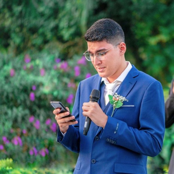 Nervous best man reading his speech from his phone during a wedding reception