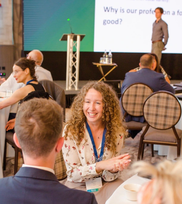 Professionals participating in a corporate public speaking and confident communication training workshop with Ed Darling delivering a keynote talk on stage