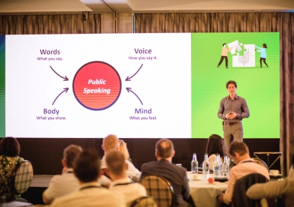 Ed Darling delivering a keynote talk on practical public speaking skills to an engaged audience at a professional conference