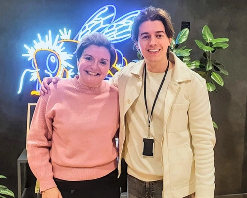 Ed Darling with a female client smiling after a 1-to-1 public speaking coaching session in Manchester, preparing her for an upcoming speech