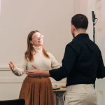 Woman coaching a man how to open body language when speaking