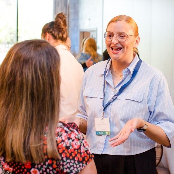 female delegate practises speaking skills during corporate team training event