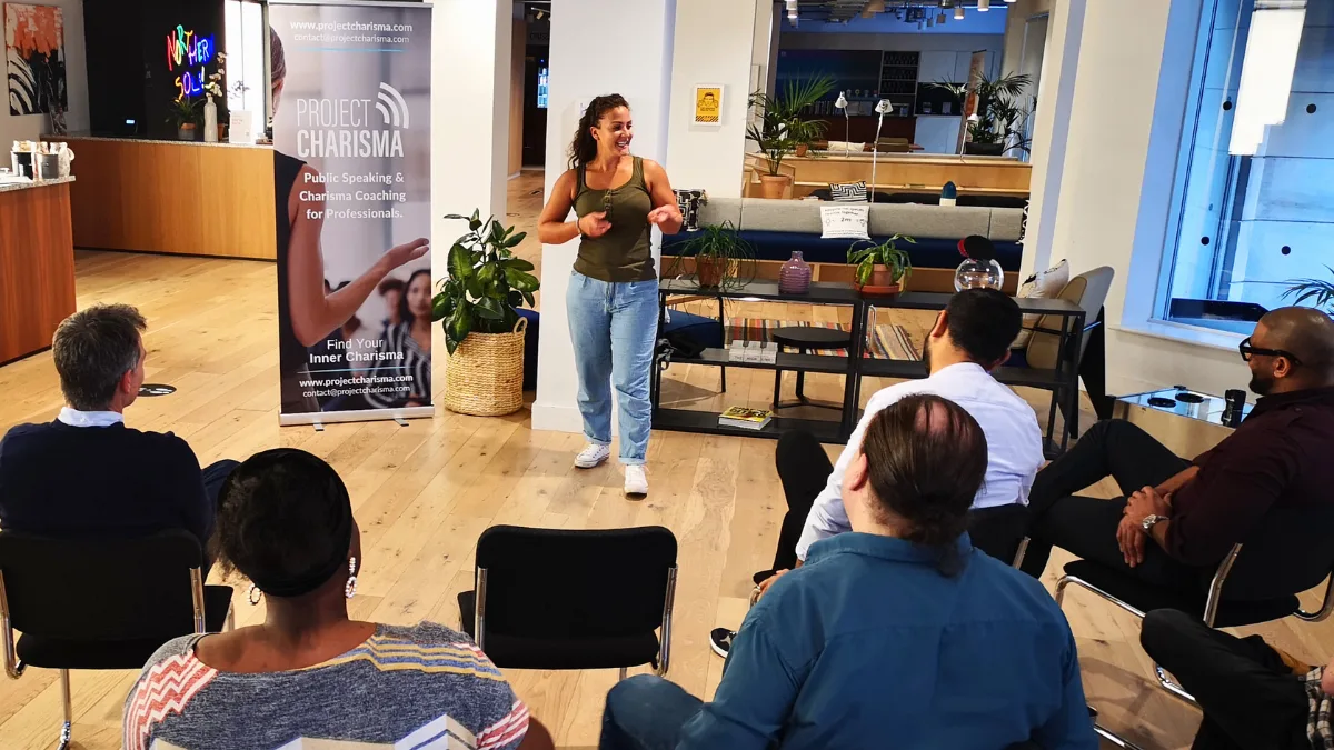 Woman confidently presenting her final pitch during Project Charisma’s 1-Day Speak & Present Masterclass in a modern office venue